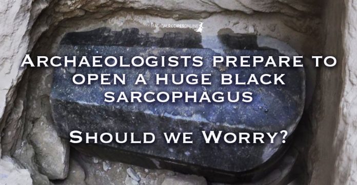 Archaeologists in Egypt prepare to open a huge black Sarcophagus